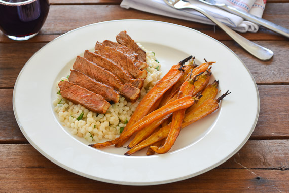 Thick-Cut Porterhouse Chipotle Steak with Roasted Baby Carrots & Minted Israeli Couscous