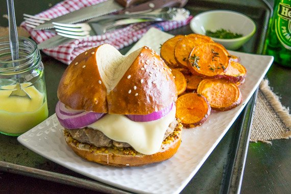 Beef Burgers on Pretzel Buns with Cheddar Sauce & Roasted Sweet Potato Rounds