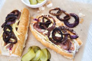 Loaded Dog with Nuremberg Bratwurst Slaw, Pickles & Crispy Onion