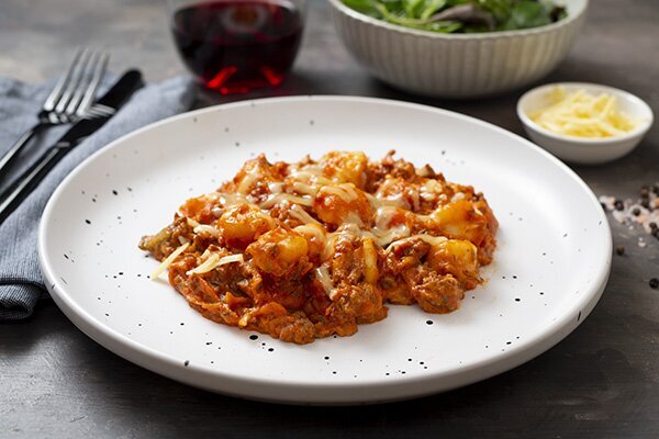 Cheesy Baked Gnocchi Bolognese with Mixed Salad Leaves and Balsamic Dressing