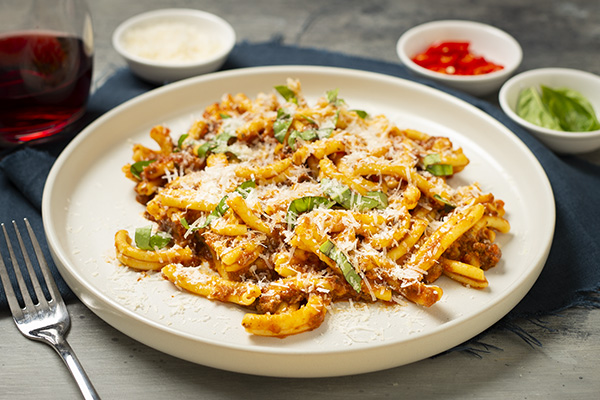Classic Casarecce Bolognese with Shaved Parmesan and Fresh Basil